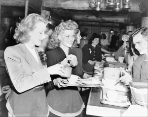 Marlene Dietrich and Rita Hayworth serve food at the Hollywood Canteen, 1942