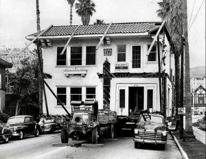 June 1952: Parked cars block moving this two-story house on Doheny Drive just south of Sunset Blvd.